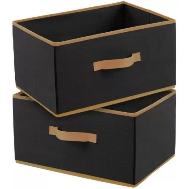 Two black storage boxes with brown handles on a white background